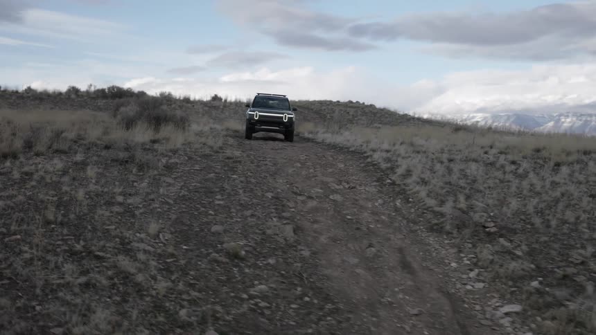 Black suv car traveling through a mountain