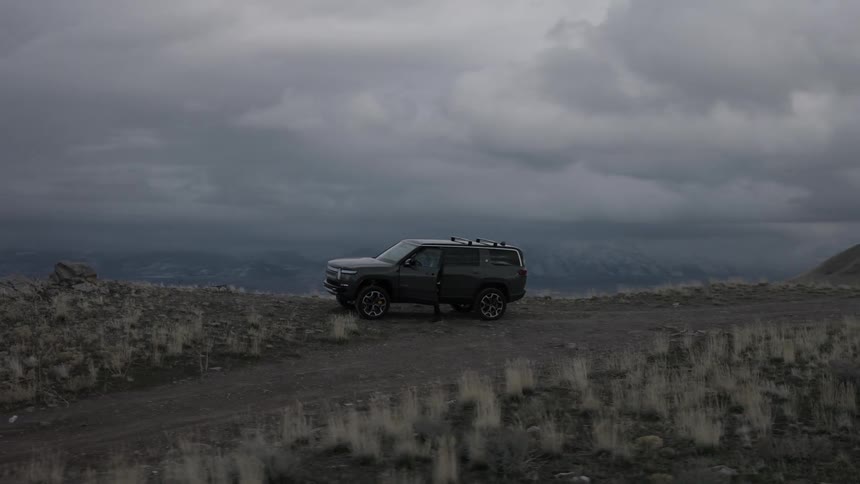 Man with a car on top of a mountain