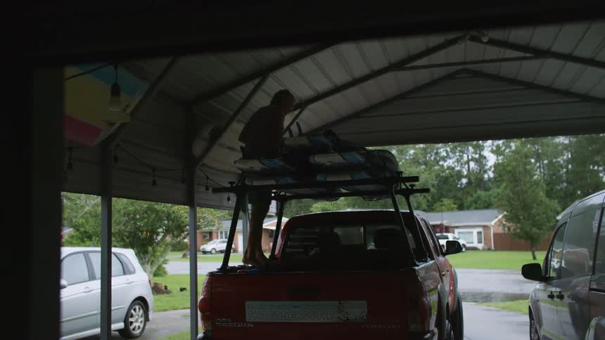 A footage of a person packing loads on a truck