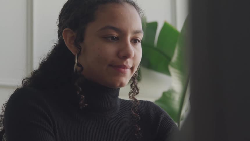 A woman is working at her computer