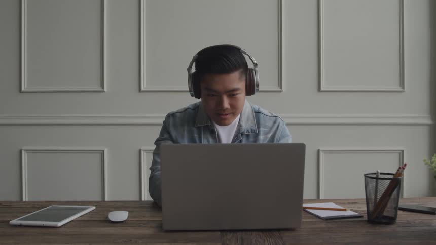 A close up clip of a man working on a laptop
