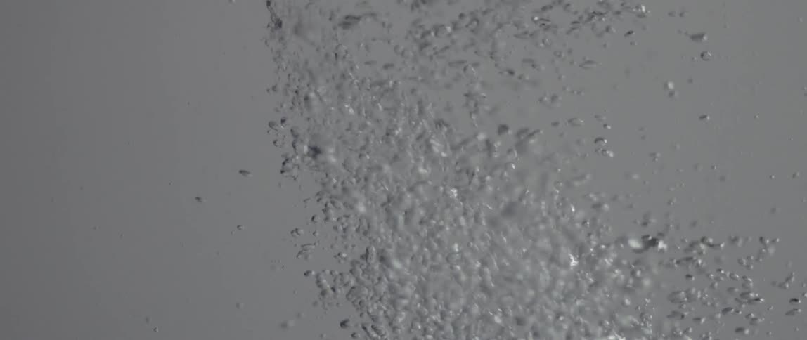 Bubbles flow upwards from a stream of liquid