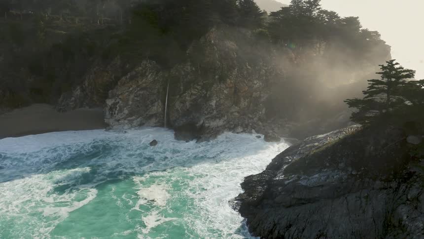 The waves below are crashing against the shoreline