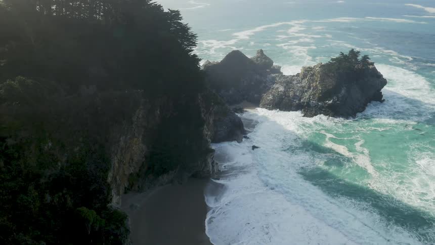 The waves crash against the coast of this rocky shore