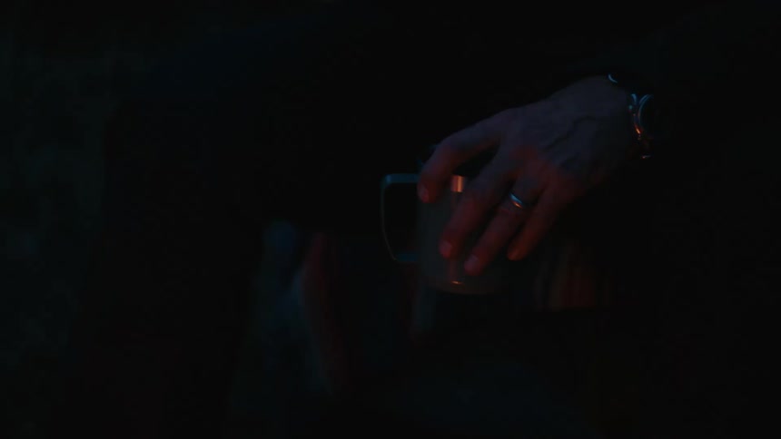Man holds a mug with fire flickers around him