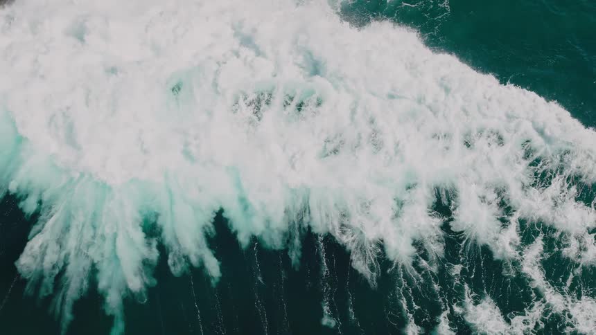 A very large wave crashes in the ocean
