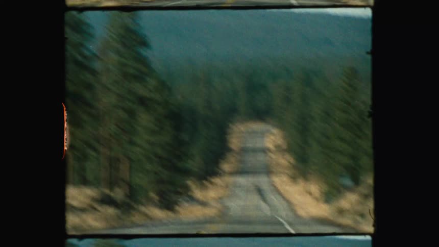 A very large mountain is off the side of the road