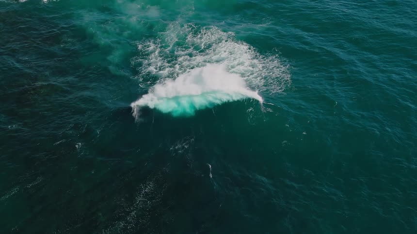 Large waves in the ocean are crashing into each other