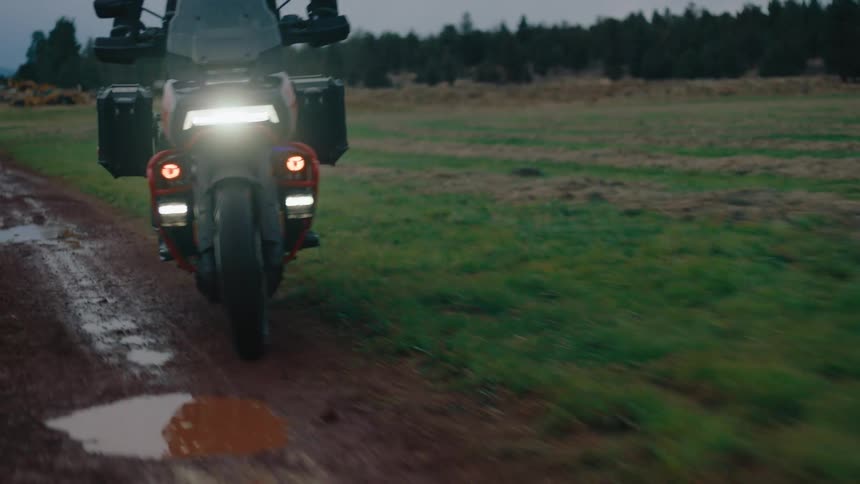 A motorcycle drives through the mud