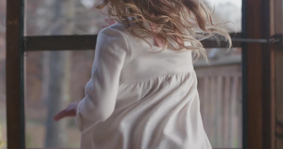A girl runs towards the door outside