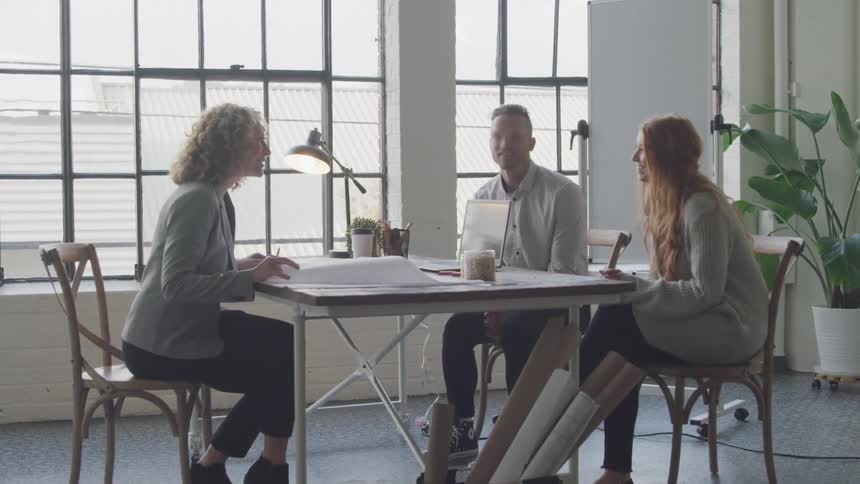 People talk and smile during a meeting