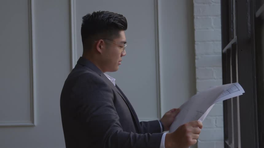 A man is looking at blueprints