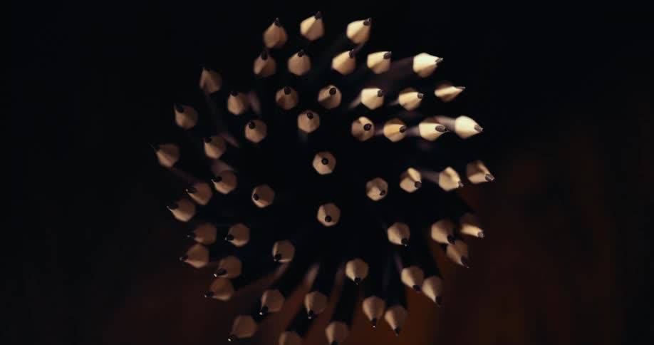 A cluster of sharpened pencils viewed from above with their pointed tips creating a varied and dynamic focal effect