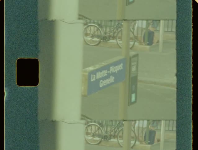 A footage of a bicycle parked by the road side