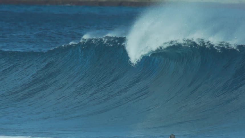 A footage of a person swimming the sea wave