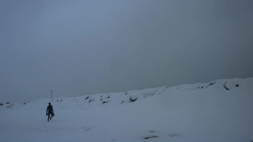 A footage of a person walking in the snow