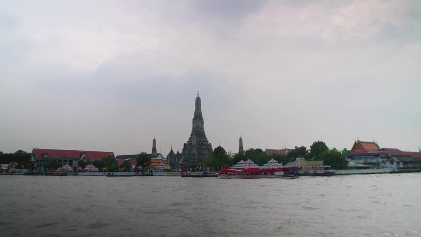 Small ferries travel past the town