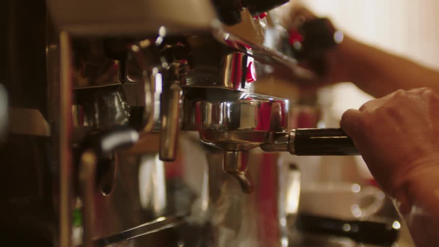 A person is making an espresso on the machine
