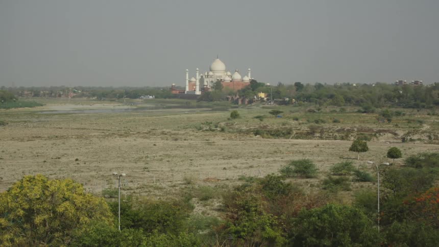A large domed temple is in the distance