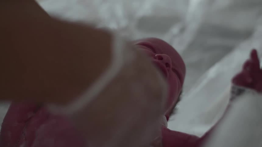 A baby is being washed in the hospital