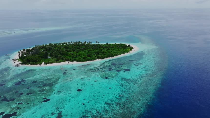 Aerial of a remote island surrounded by white sandy shoreline