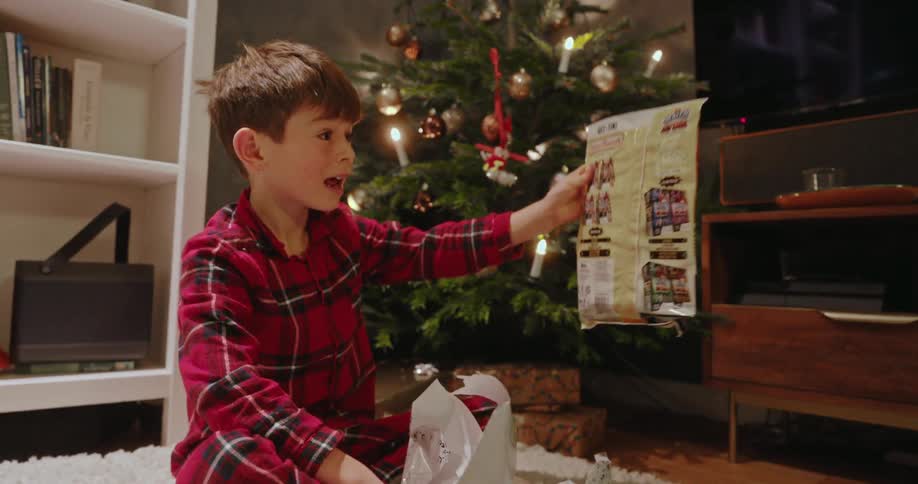 A footage of a boy unboxing a gift