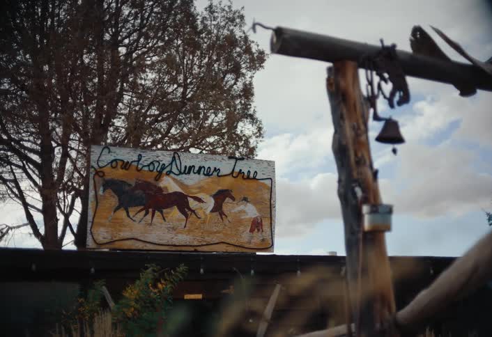 A large sign is on top of the shop