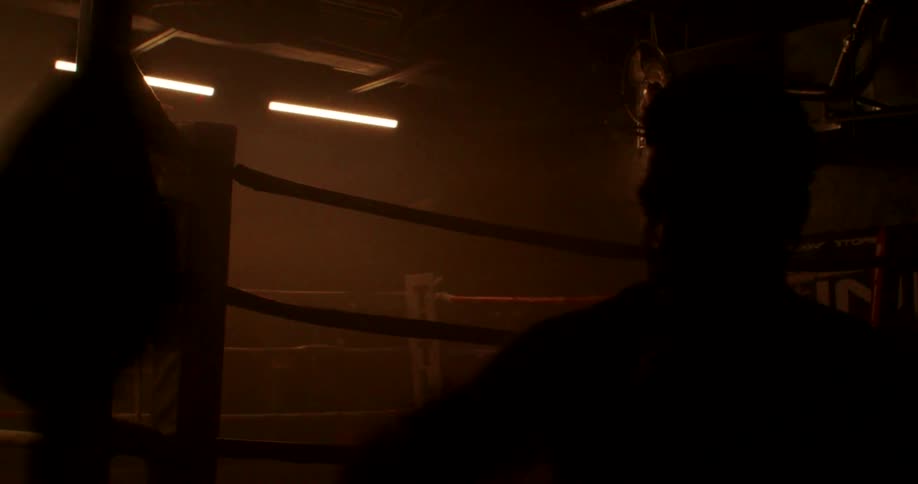 A man is practicing his boxing on gym equipment