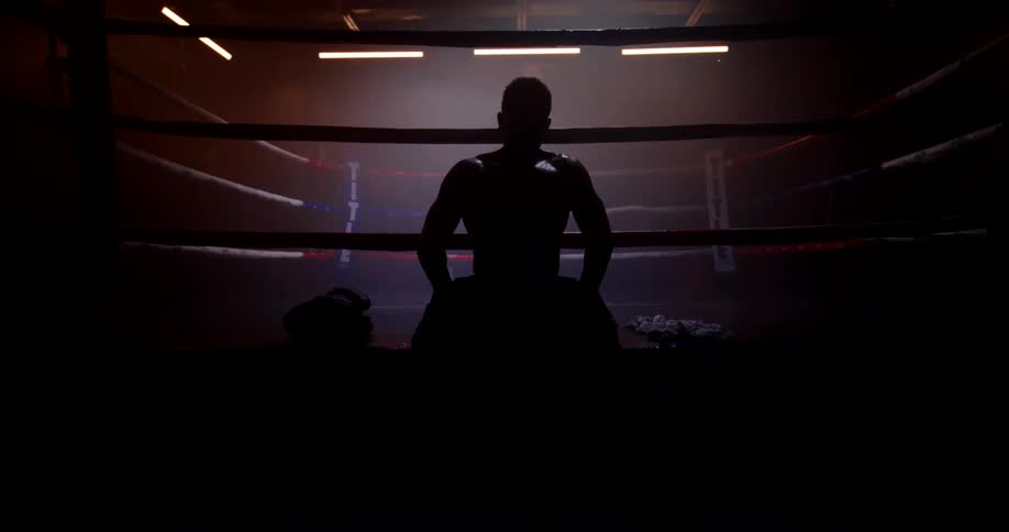 A man is sitting in the arena as he gets ready for a boxing match