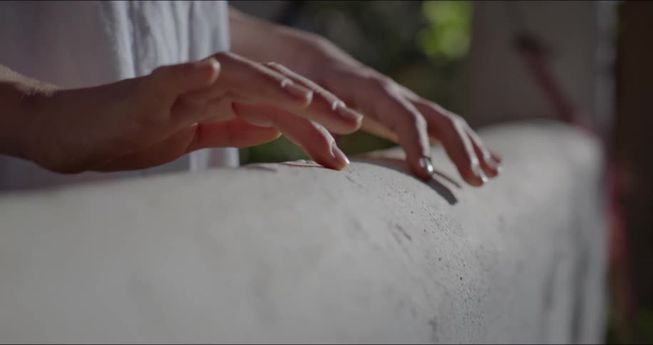 A person traces his fingers over the wood