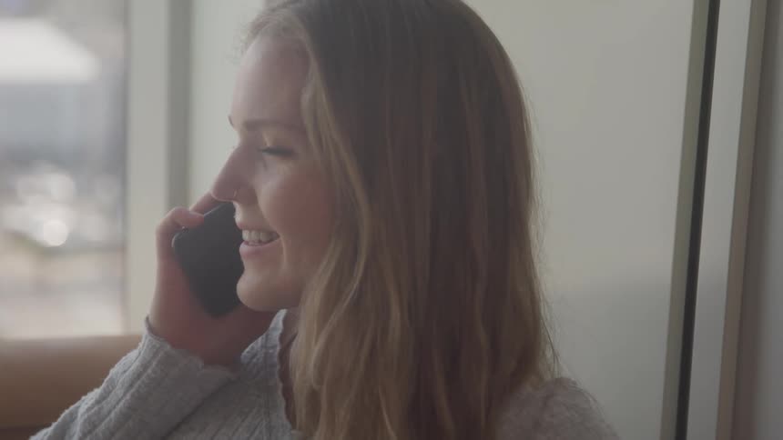 A woman is talking on her cell phone