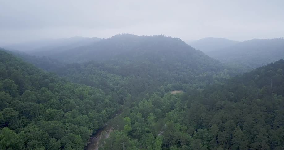 Tree covered hills and mountains on a hazy day