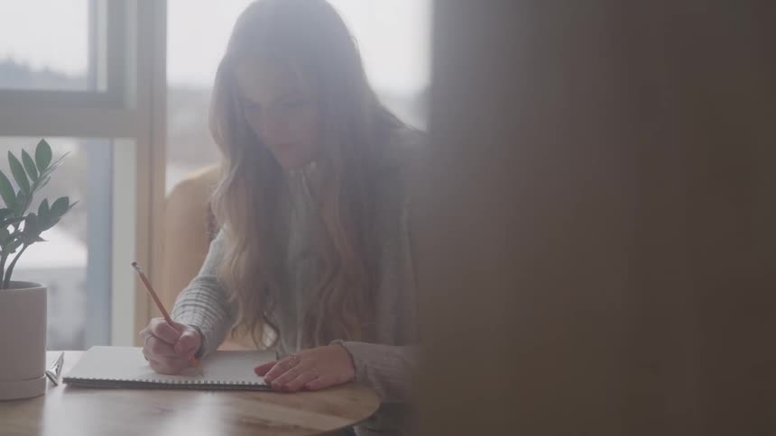 A woman is drawing on a pad