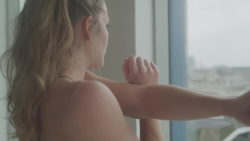 Girl stretching in front of the window