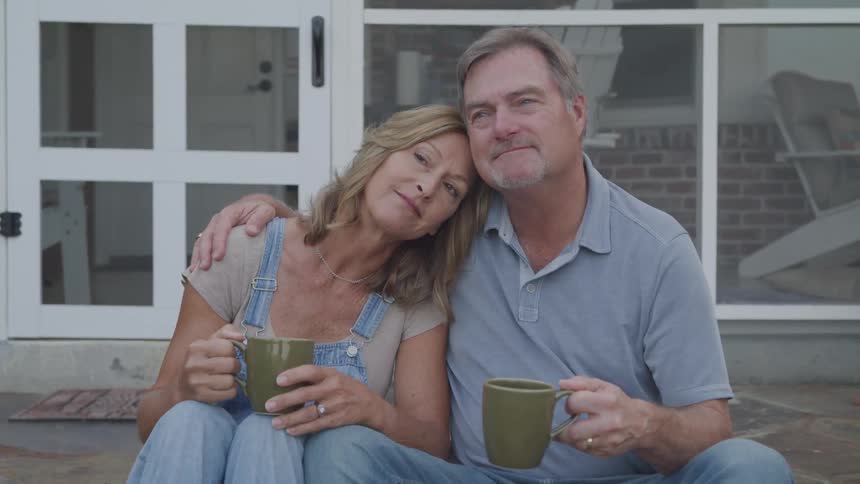 A footage of a man and woman seating outdoor