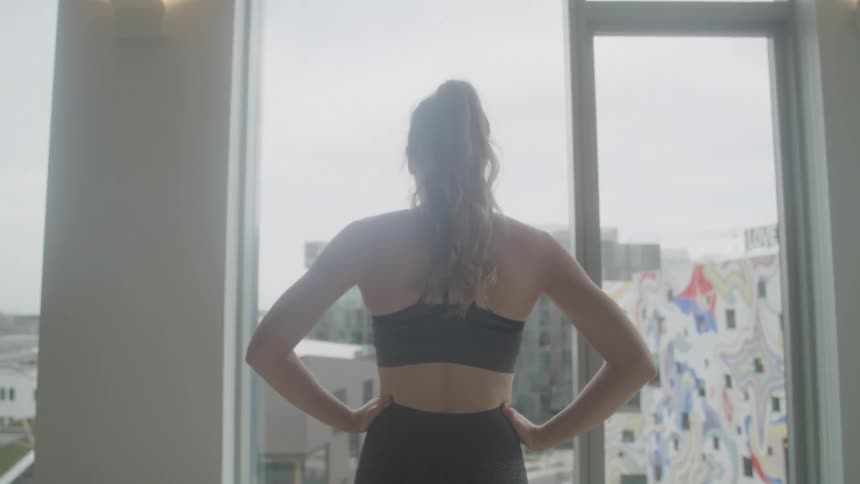 A footage of a person a standing by the window