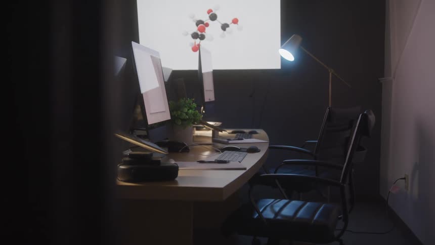 The office is empty with the monitor showing an image