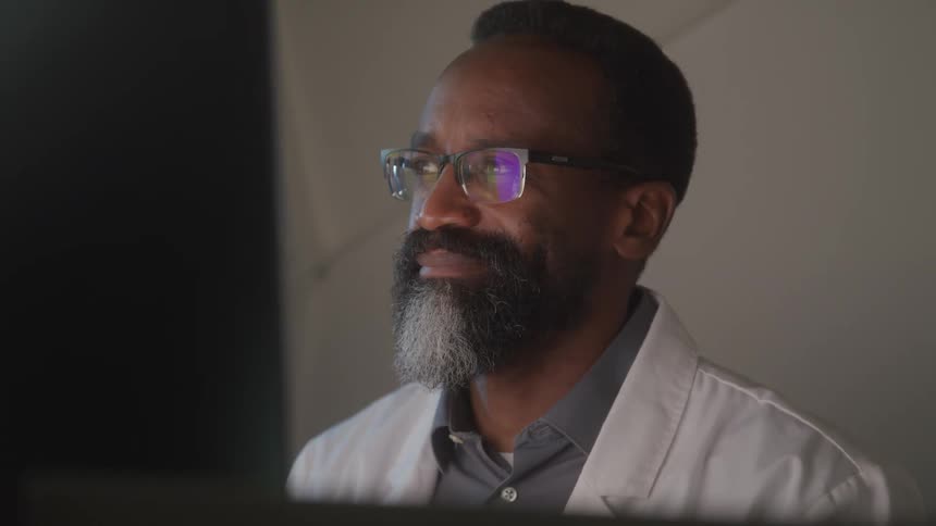 A man is reading something on the monitor