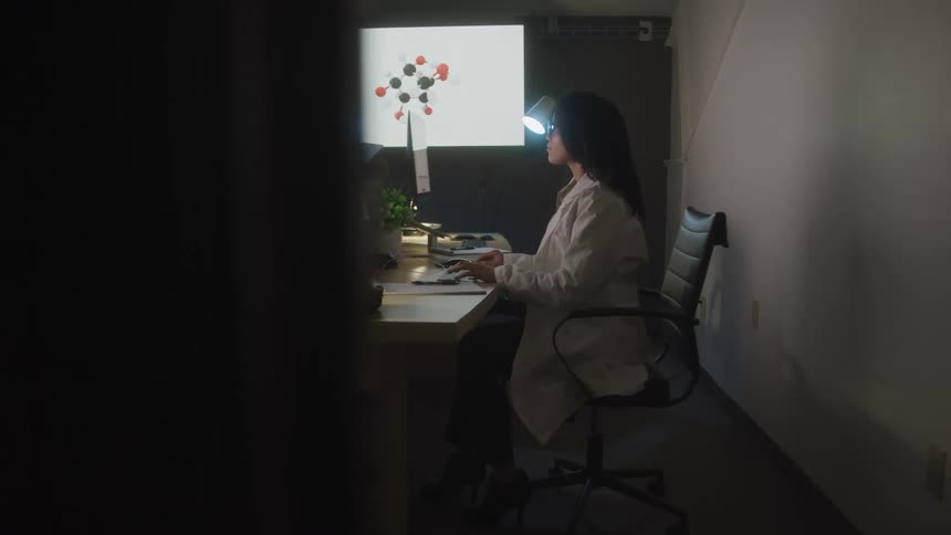 A footage of a lady typing on a computer