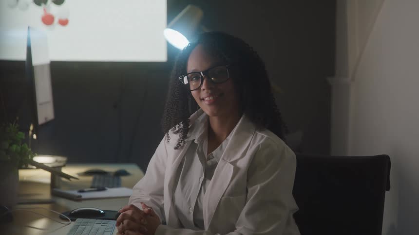 A woman smiles in he office