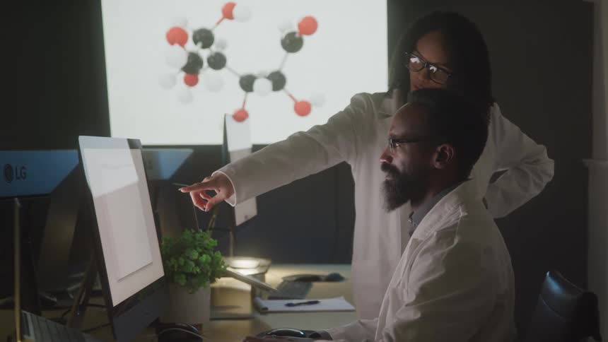 Two workers talk in the lab