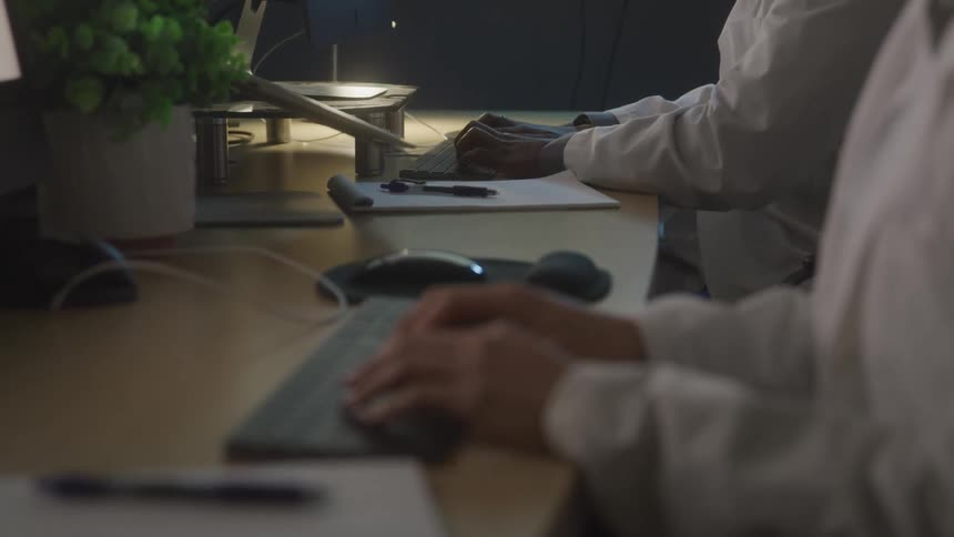 Coworkers are typing on their computers