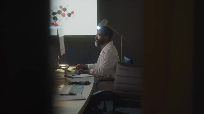 A man is working at his computer in the conference room
