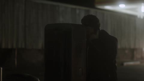 A man looks around before picking up the phone