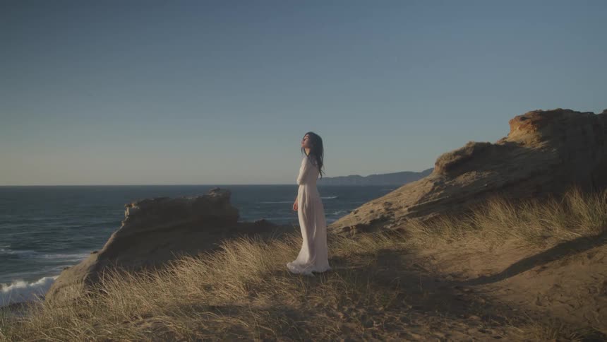 Girl dressed in white on a raised coast