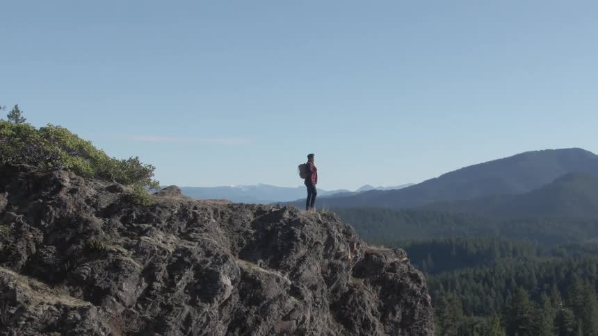A footage of a person standing on a mountainous area