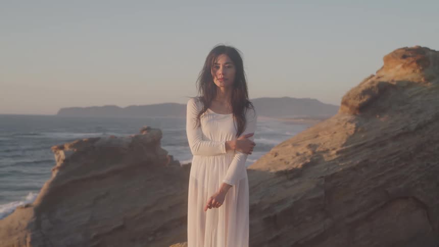 Girl in white dress in a landscape by the sea