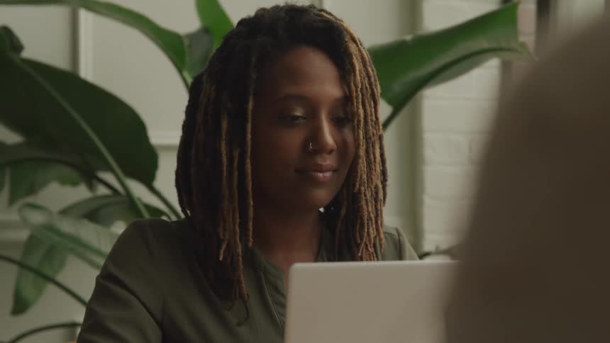 A footage of a lady operating on a laptop