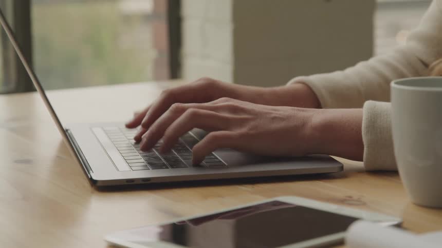 A person types on a keyboard