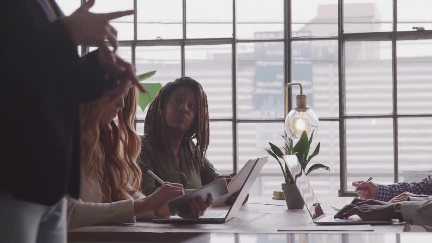 A footage of people listening to a presentation in the office